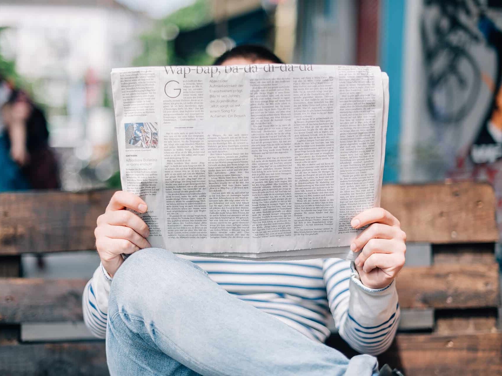 man reading news paper about ERP software