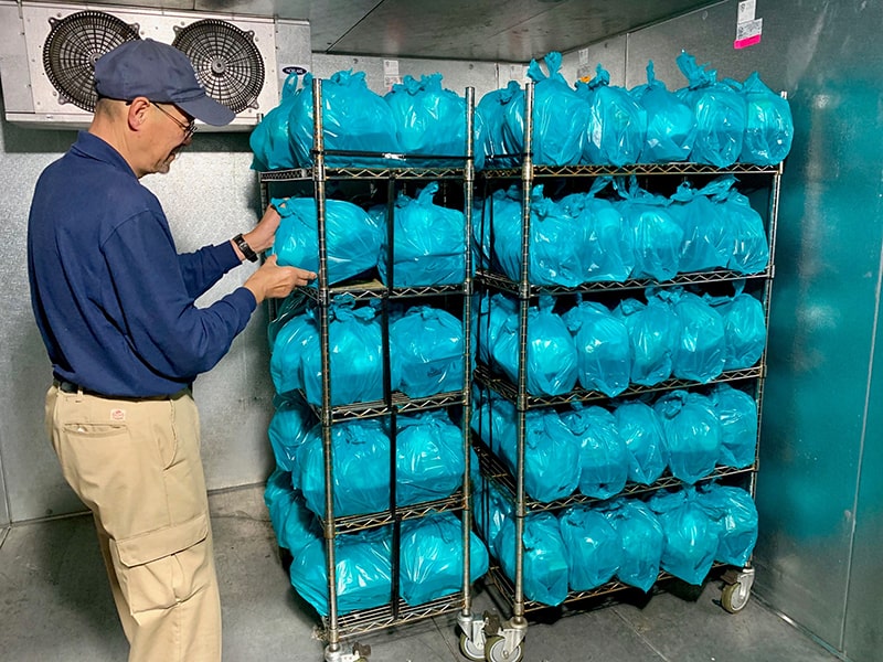 meals on wheels employee checking inventory 