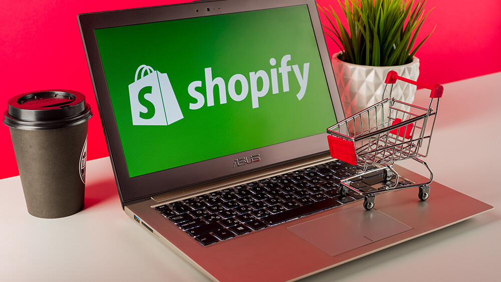 An image of a the Shopify logo on a latptop with inventory management strategies implied.