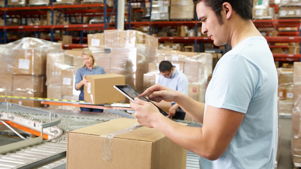 worker using tablet to manage consumable inventory for non-profit business