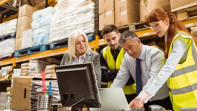 supply chain managers using kechie erp software for their non-profit business in a warehouse