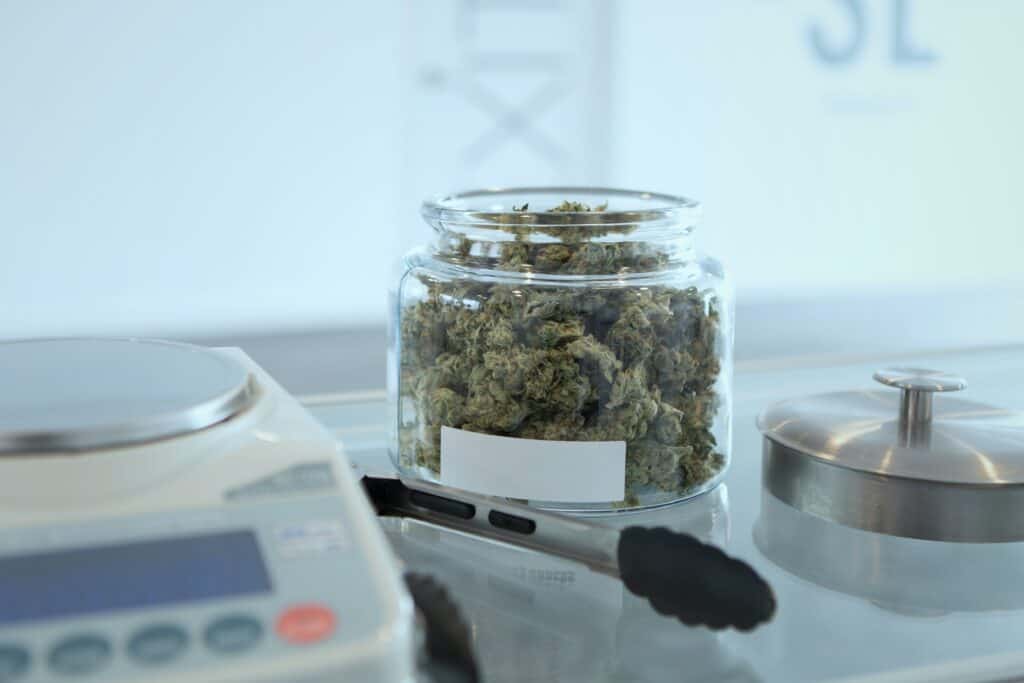 Cannabis in a jar waiting to be portioned out for a sale