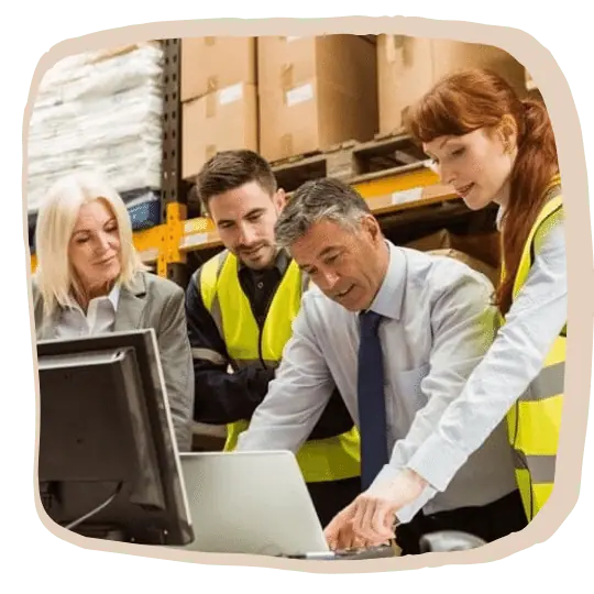 This is an image of warehouse workers finding something on the computer.
